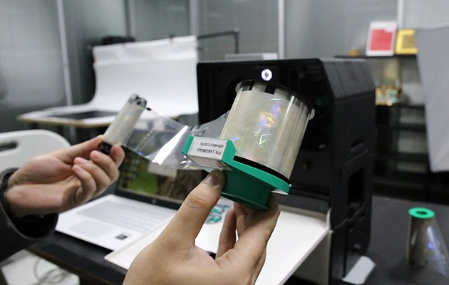 Holograms are applied to ID cards using a special laminator