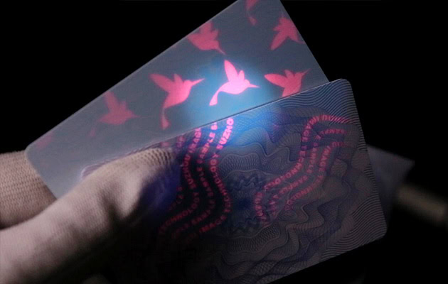 ID card back with UV security printing revealed under ultraviolet light showing hidden logo and texts